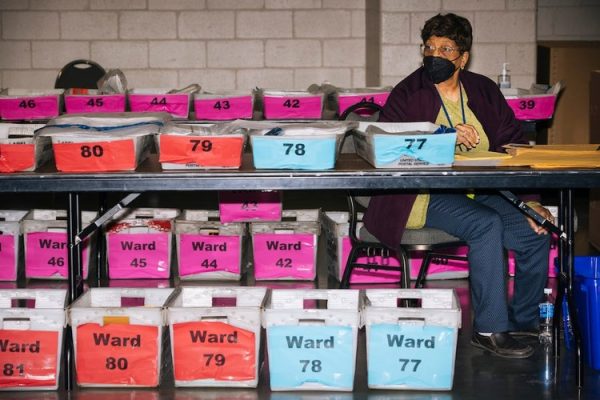photo of woman counting ballots