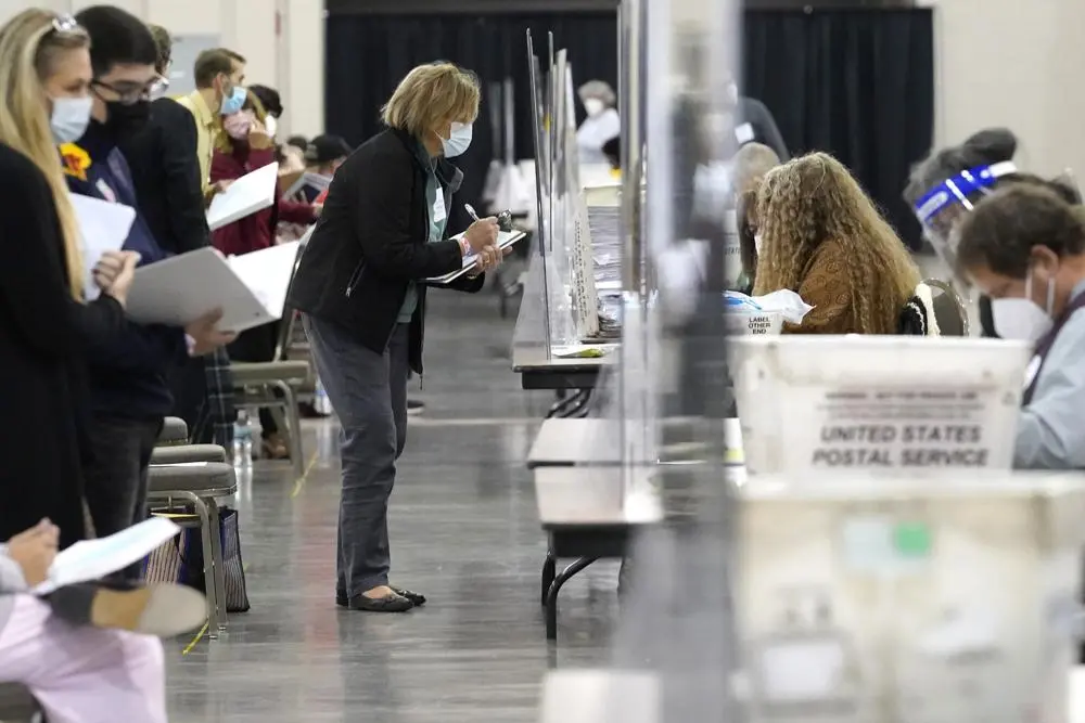 Recount observers watch ballots during a Milwaukee hand recount of Presidential votes at the Wisconsin Center