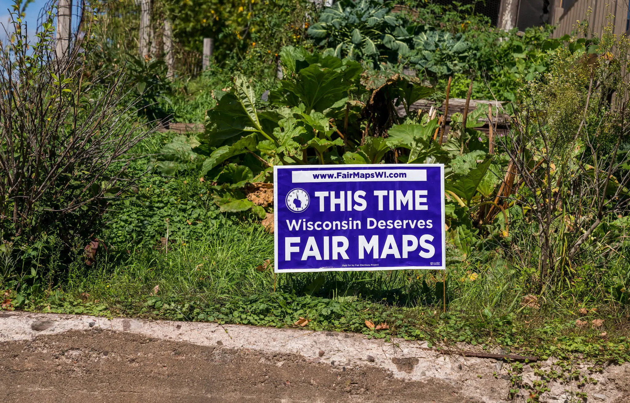 A yard sign in Mellen, Wisconsin reads: “This Time Wisconsin Deserves Fair Maps,” paid for by the Fair Elections Project